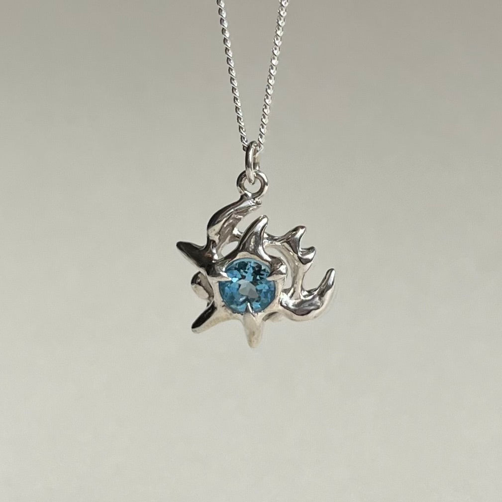 Mini KHAOS sterling silver necklace with round cut Swiss blue topaz gemstone