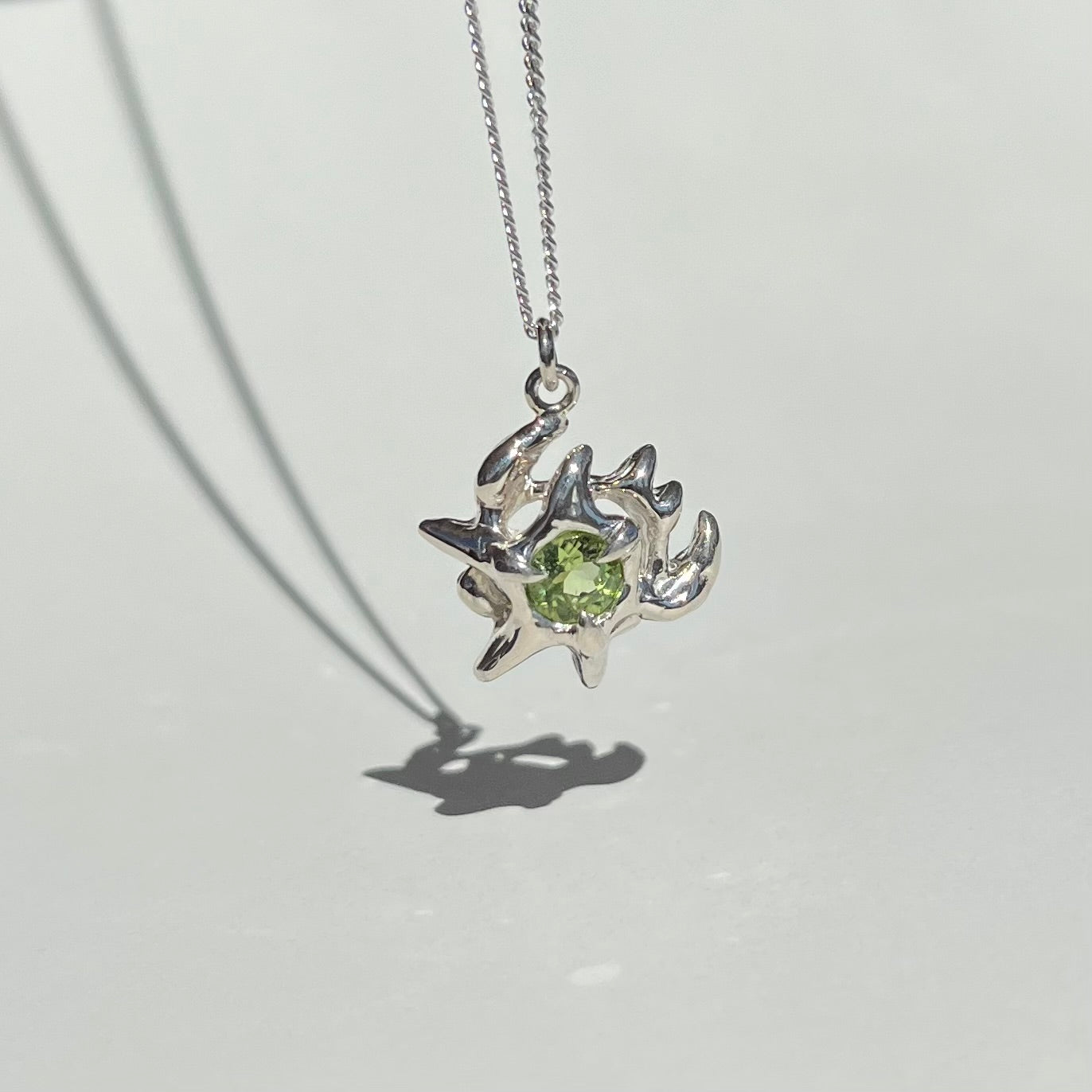 Mini KHAOS sterling silver necklace with round cut peridot gemstone